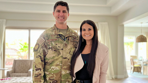 female entrepreneur stands with man in military uniform